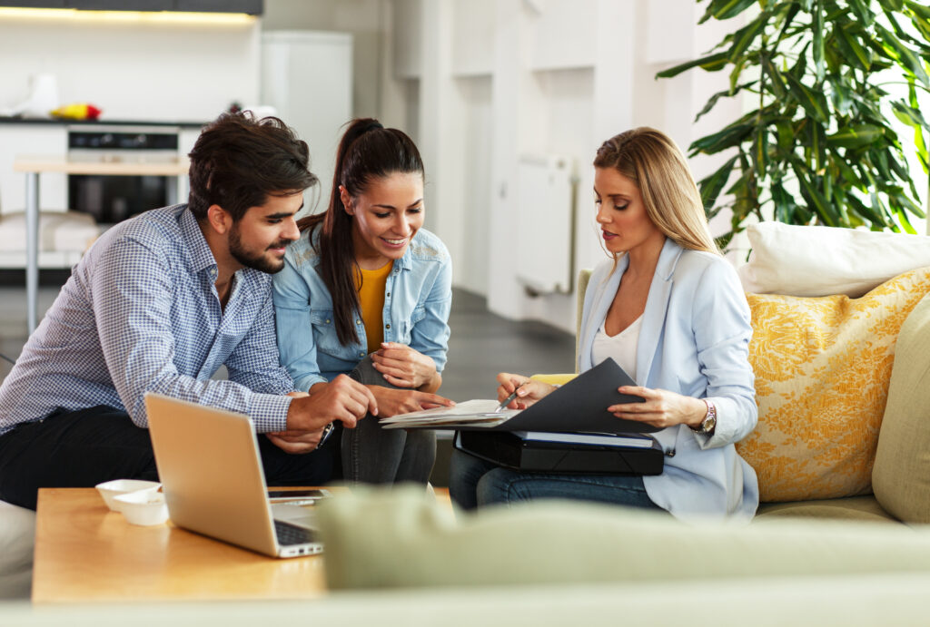 Couple making an offer on a home with real estate agent