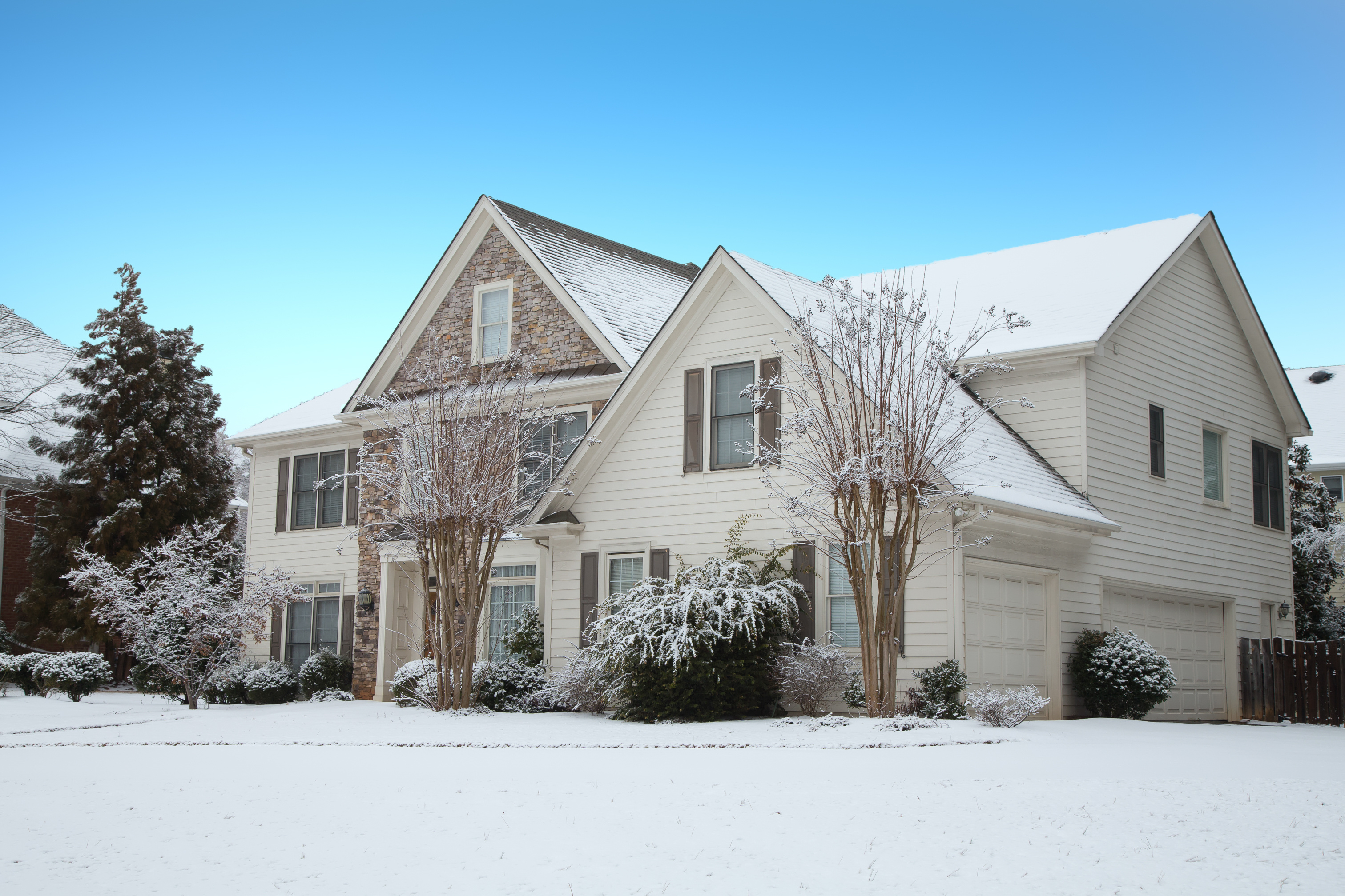 beautiful craftsman home covered in snow