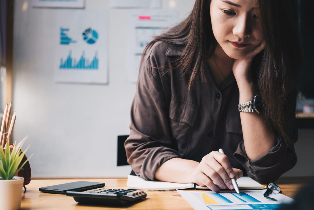 woman going over finances for selling and buying a house at the same time