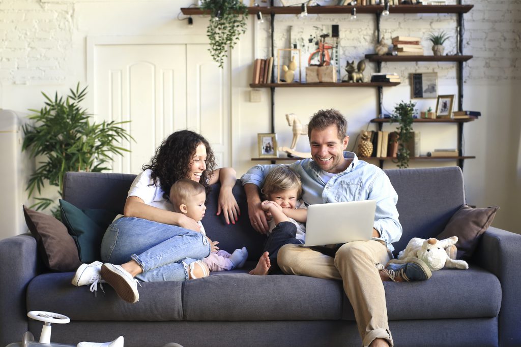 young family browsing homes on a computer