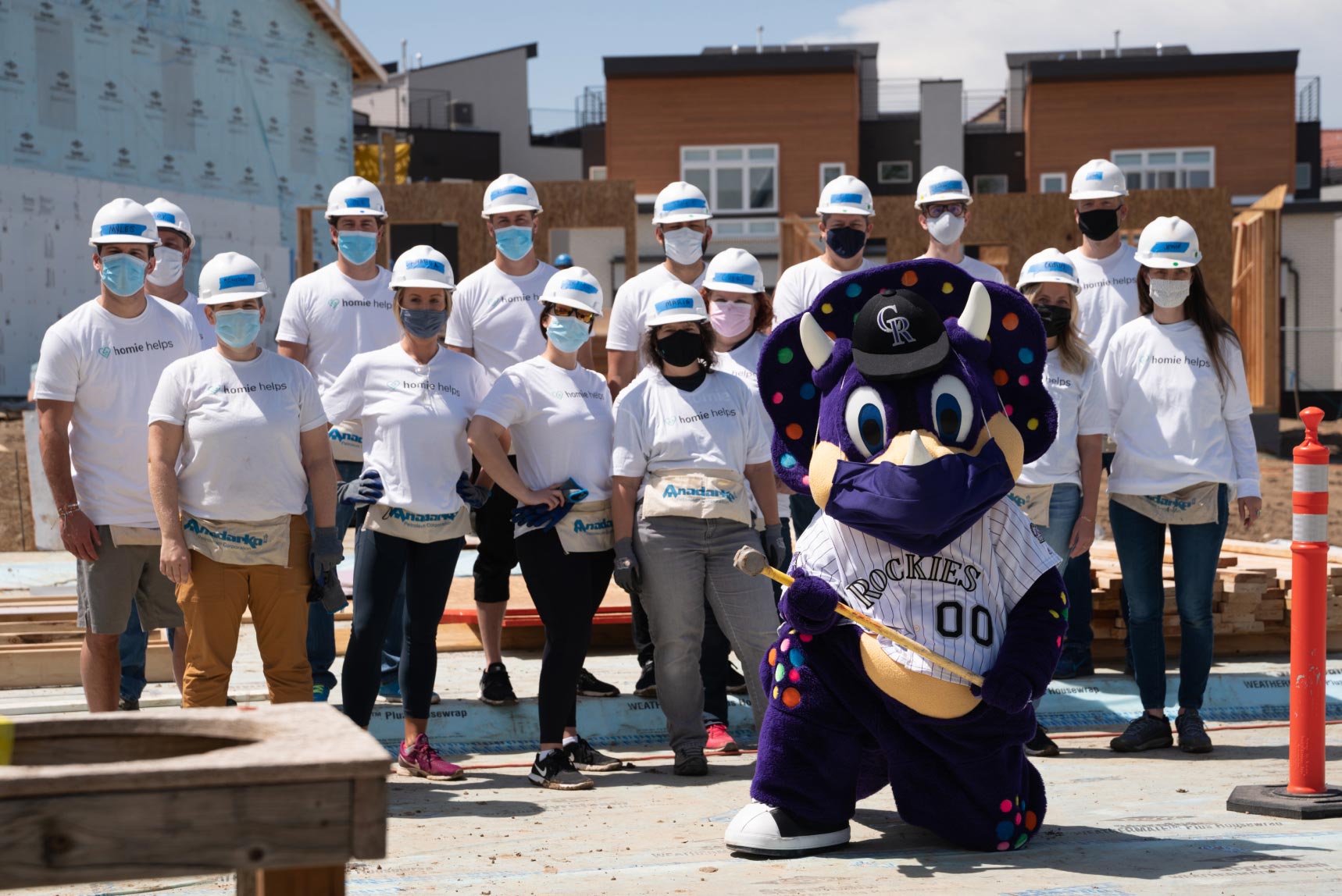 homies and the rockie's mascot working on a home for habitant for humanity in denver