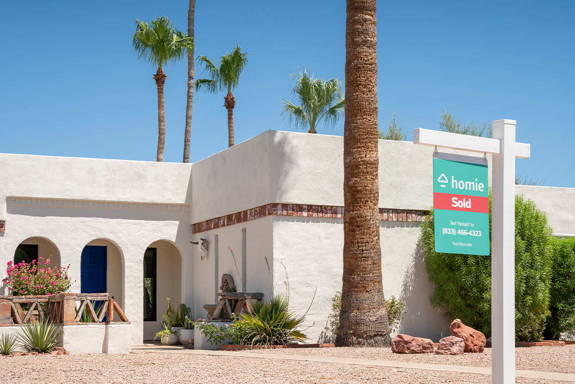 arizona home with homie for sale sign in the front yard