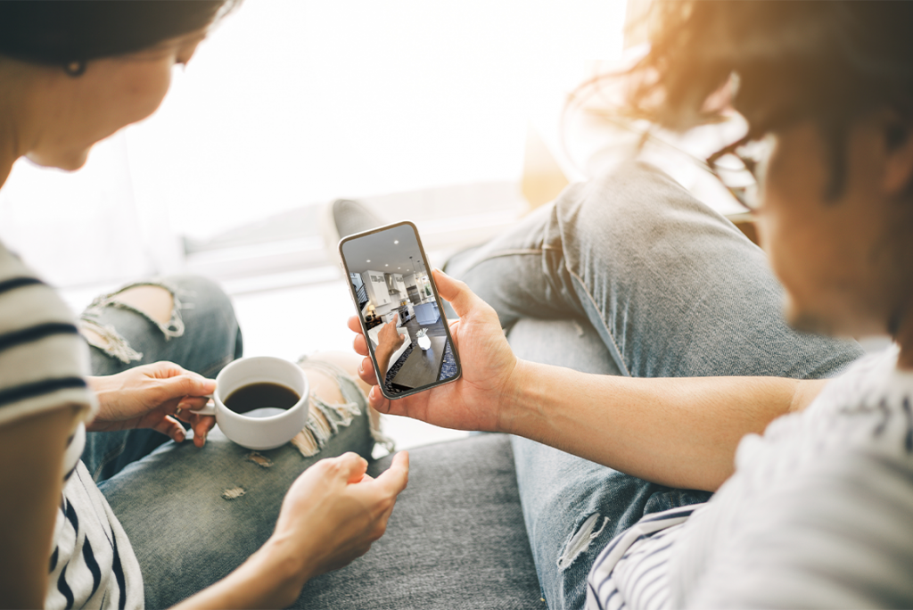 two people looking at homes online from their couch