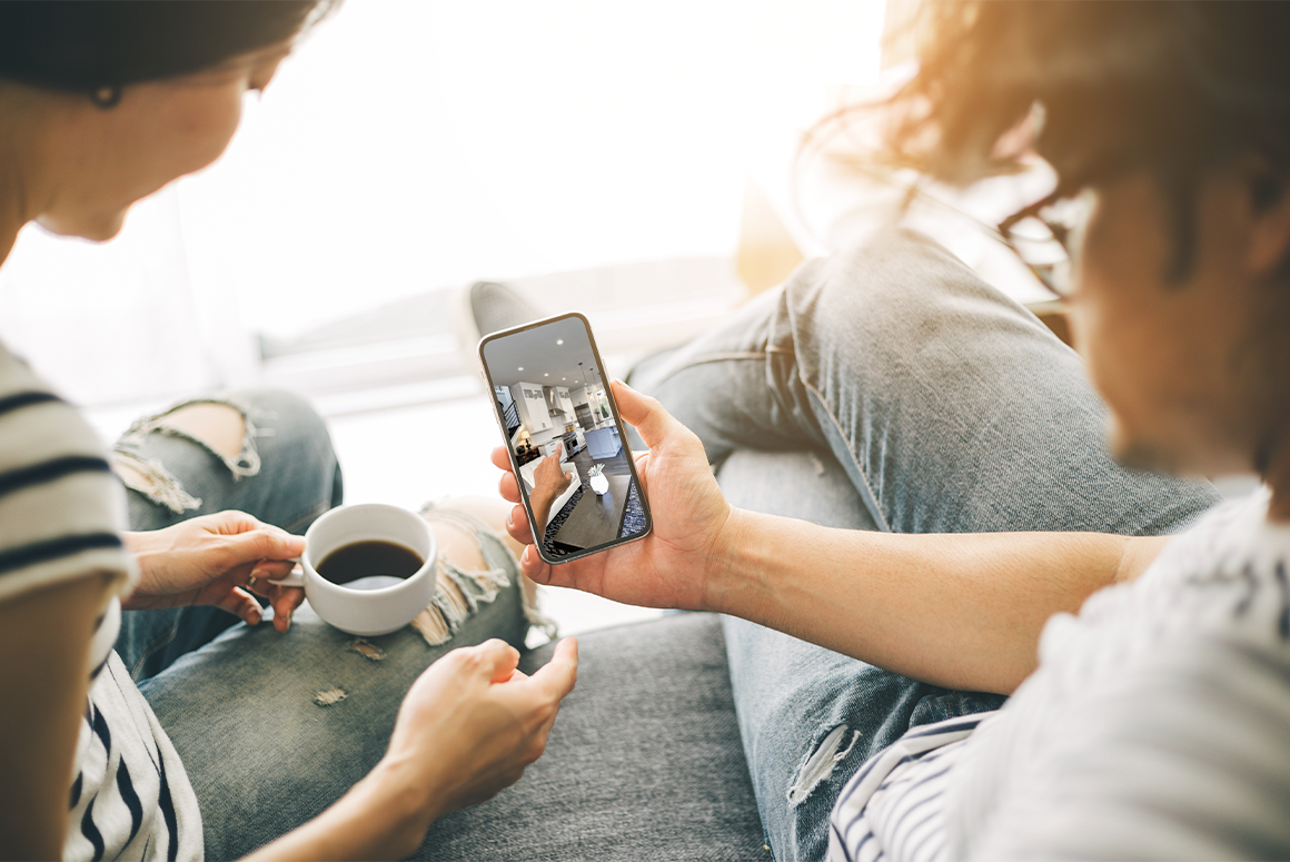 two people looking at homes online from their couch