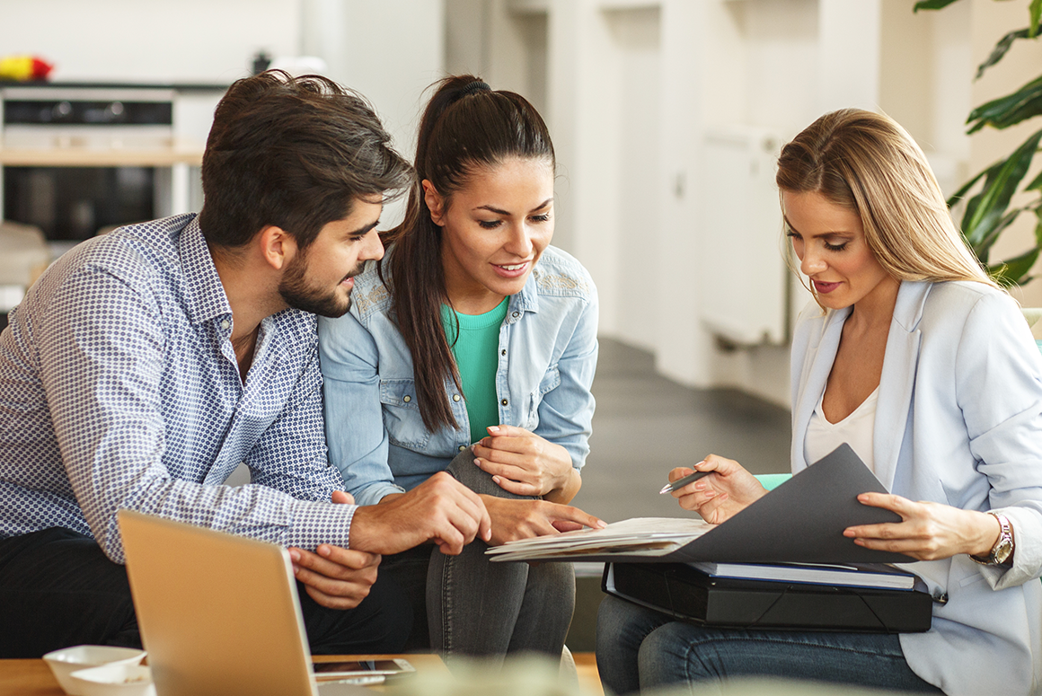 couple discussing paperwork with an agent