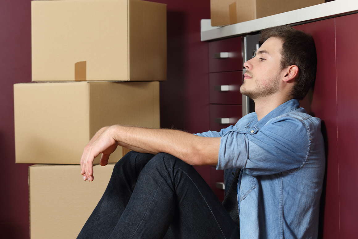 A man sitting down looking stressed