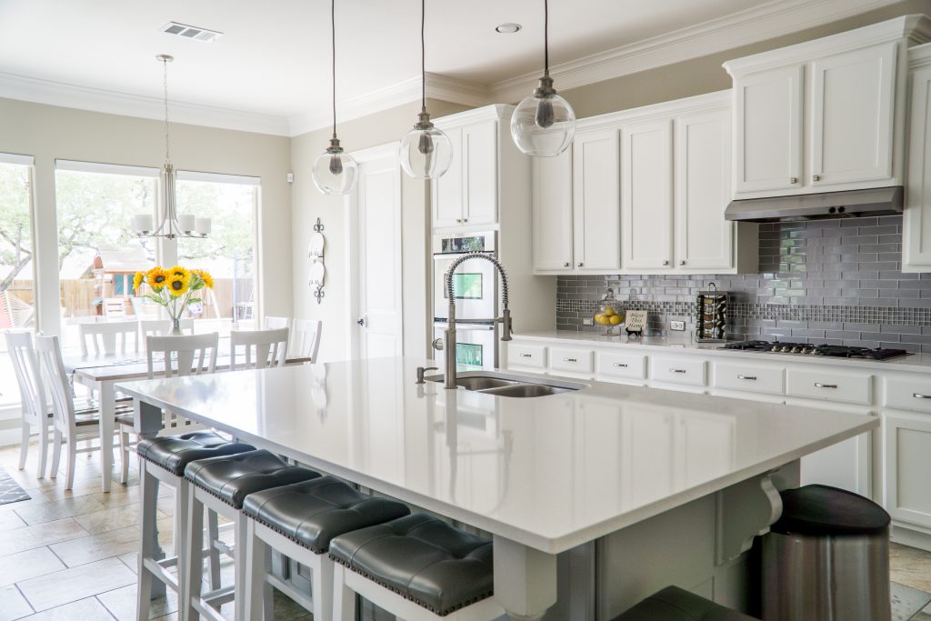 updated, clean kitchen with white cabinets and neutral accents