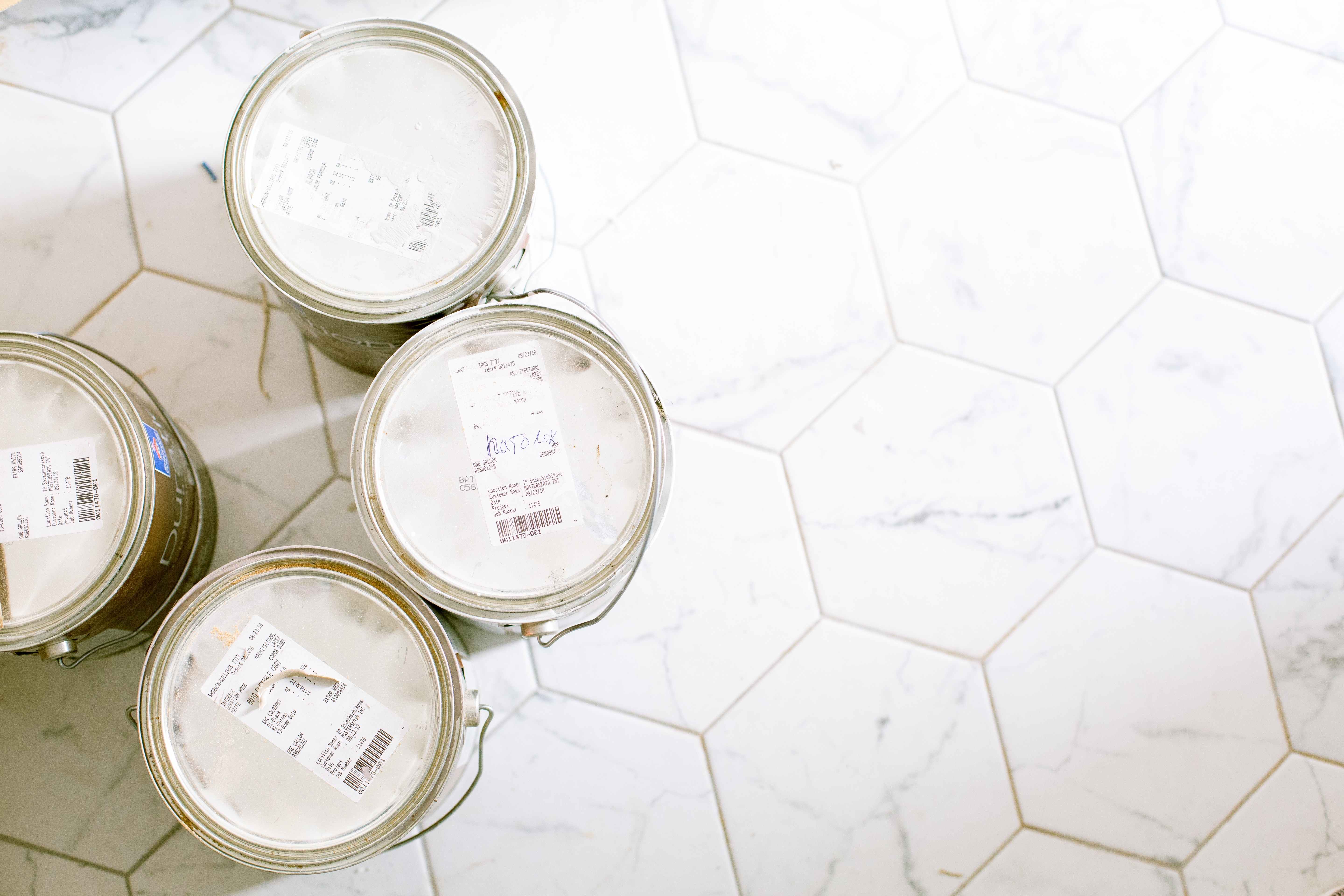 paint cans on a tile floor