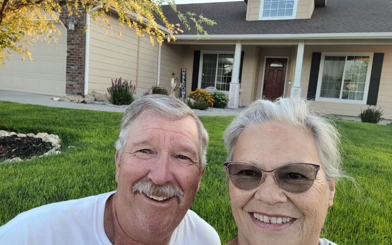 Reta & Rod in front of their home home