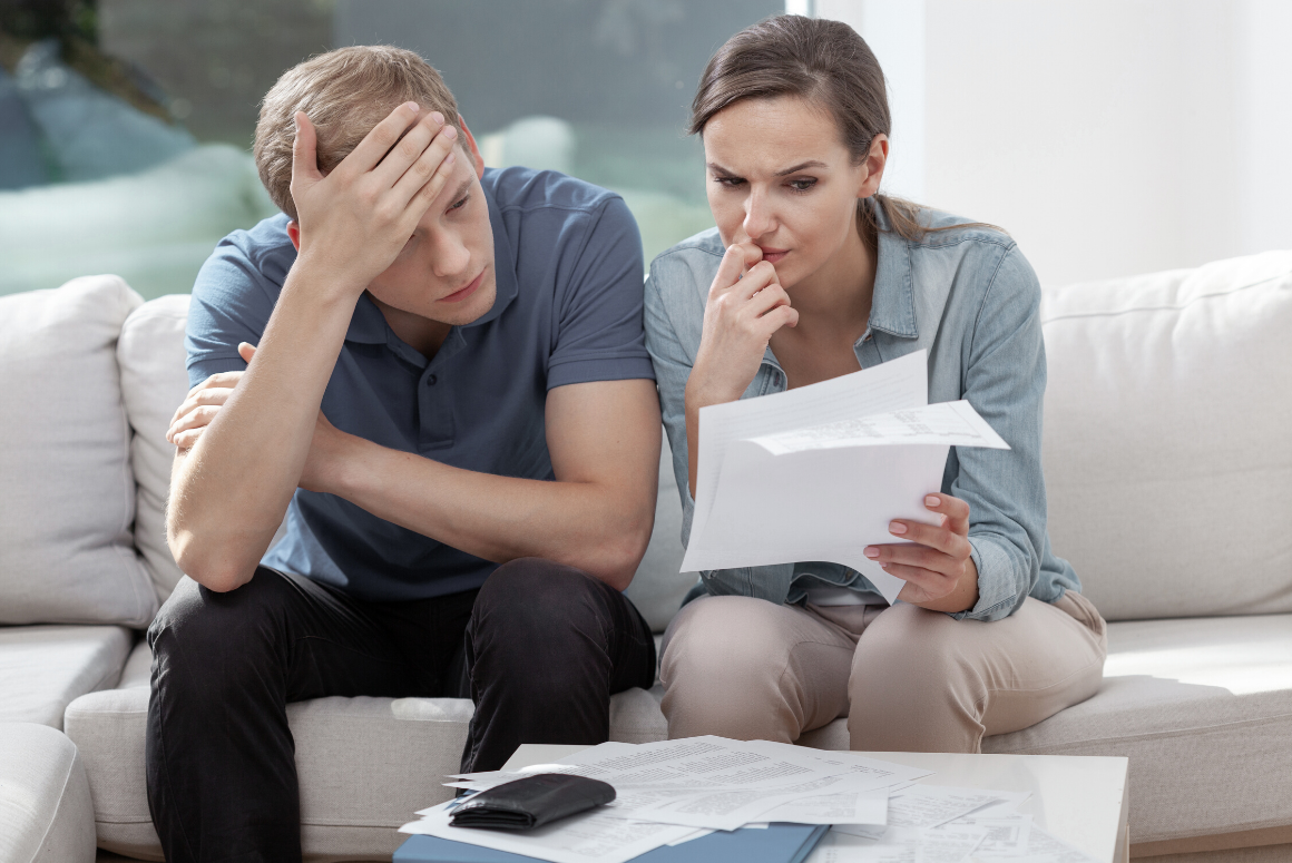 couple looking at paperwork together, stressed