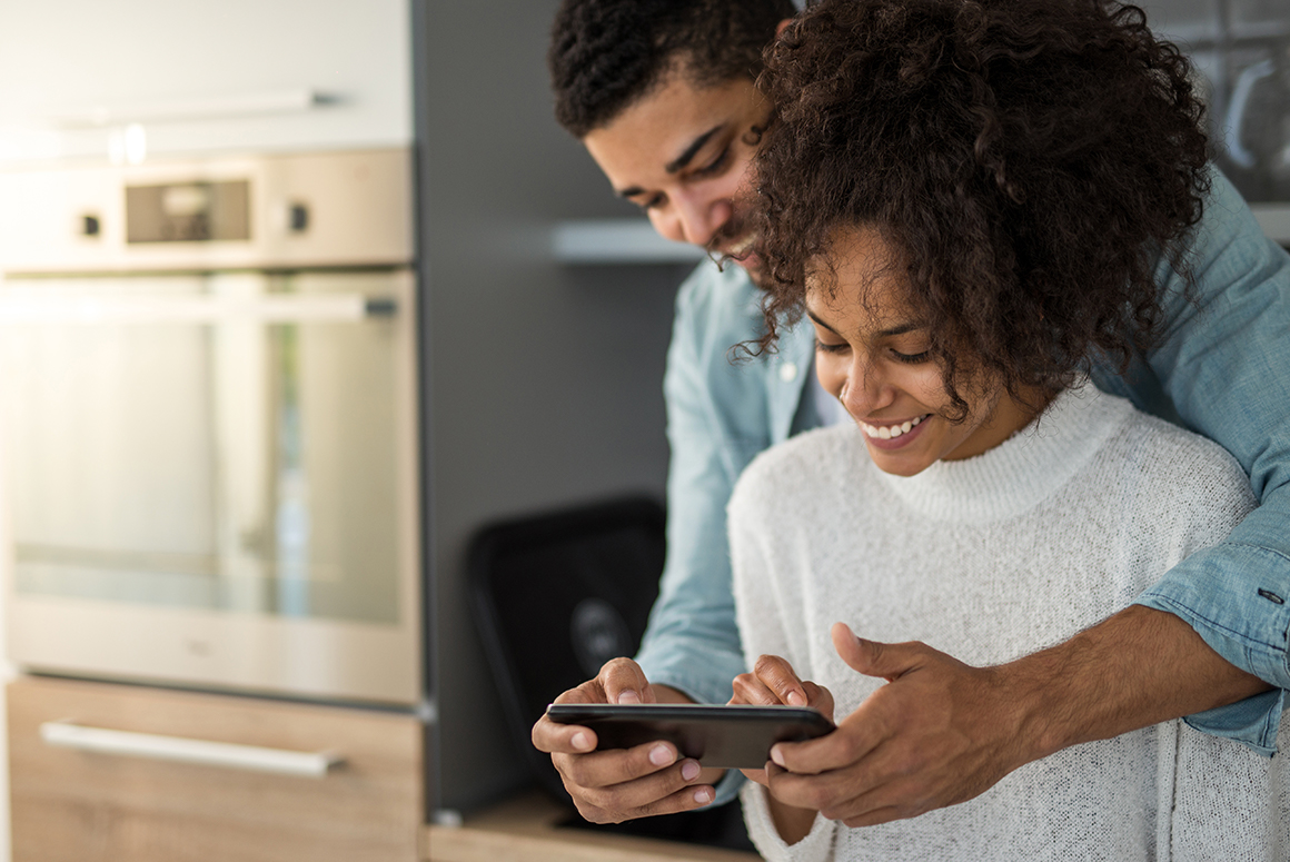 black couple looking at a phone together